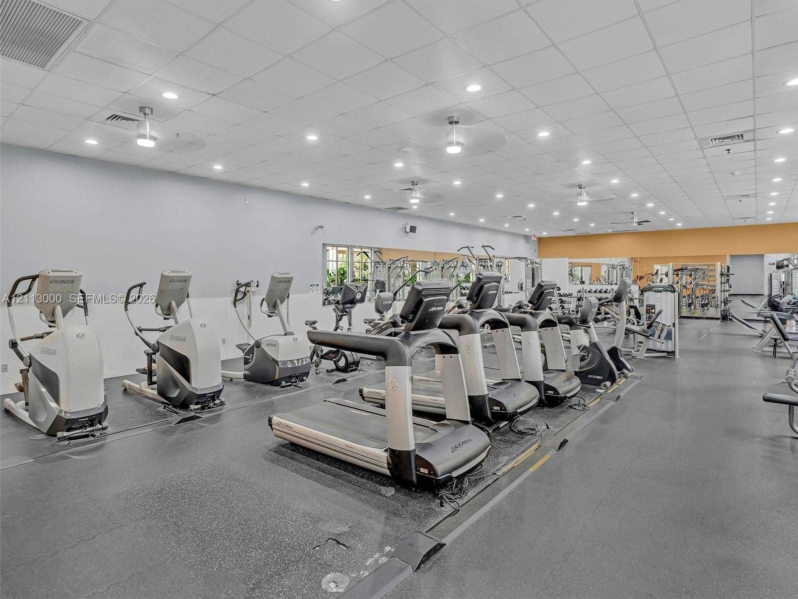 10860 La Salinas Circle, Boca Raton, FL 33428 Fitness center featuring high-contrast rubber flooring, recessed ceiling lighting, and wall-to-wall mirrors