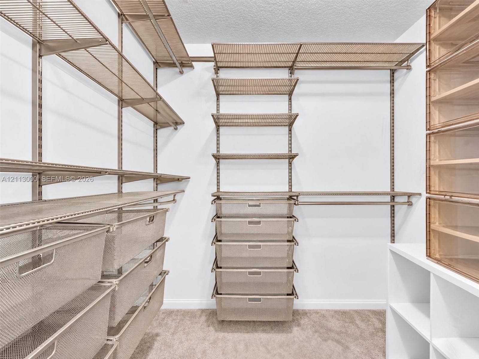 10860 La Salinas Circle, Boca Raton, FL 33428 Customizable closet organization system featuring modular metal shelving, pull-out wire drawers, integrated hanging rods, and built-in tiered cabinetry