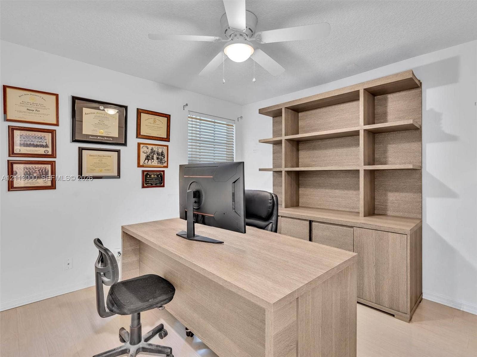 10860 La Salinas Circle, Boca Raton, FL 33428 Built-in floor-to-ceiling wood-finish cabinetry, wood-finish flooring, and overhead ceiling fan with integrated light fixture
