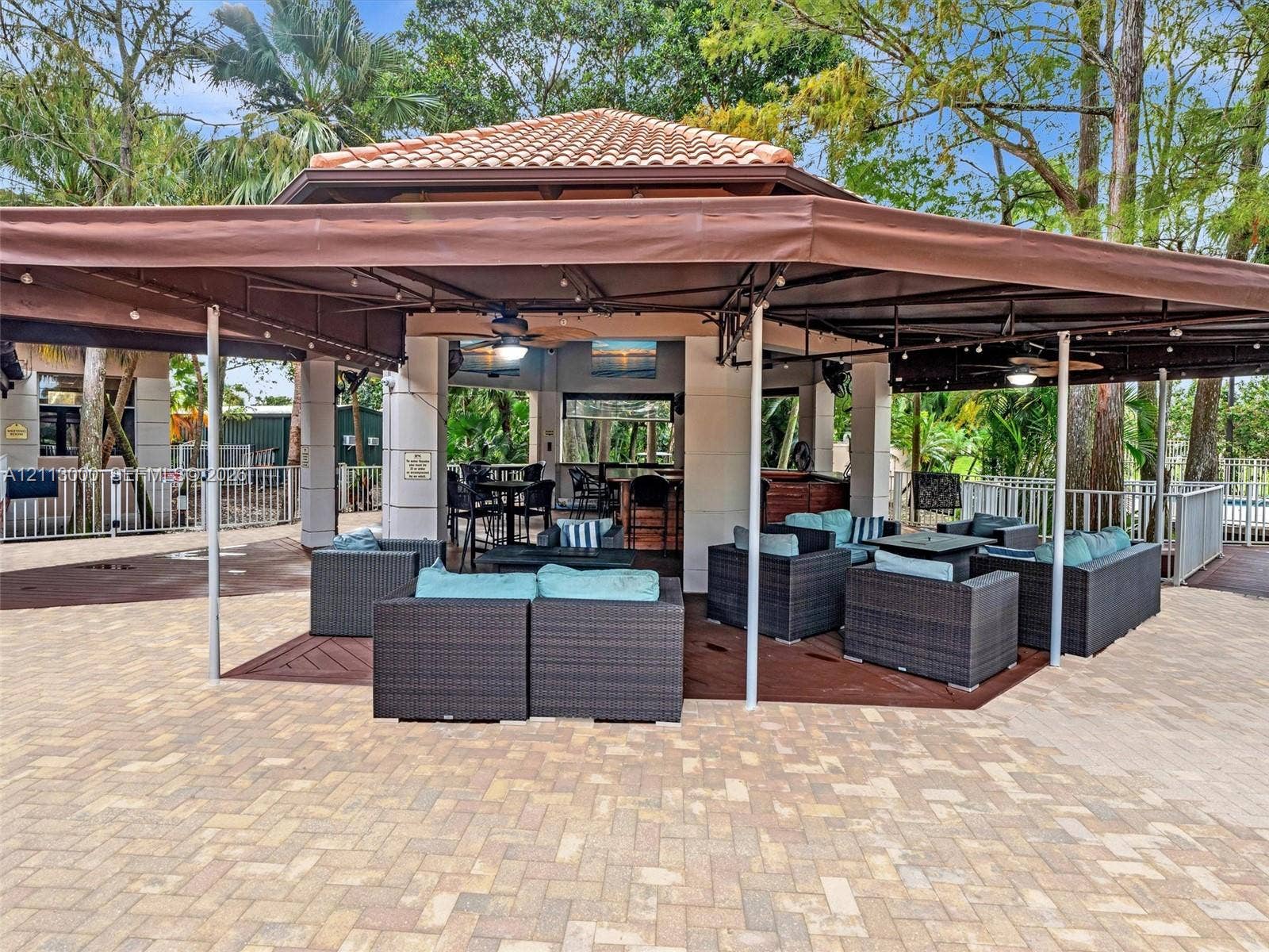 10860 La Salinas Circle, Boca Raton, FL 33428 Outdoor pavilion featuring a terracotta-tiled roof, built-in bar, recessed ceiling lighting, overhead fans, and paved hardscaping