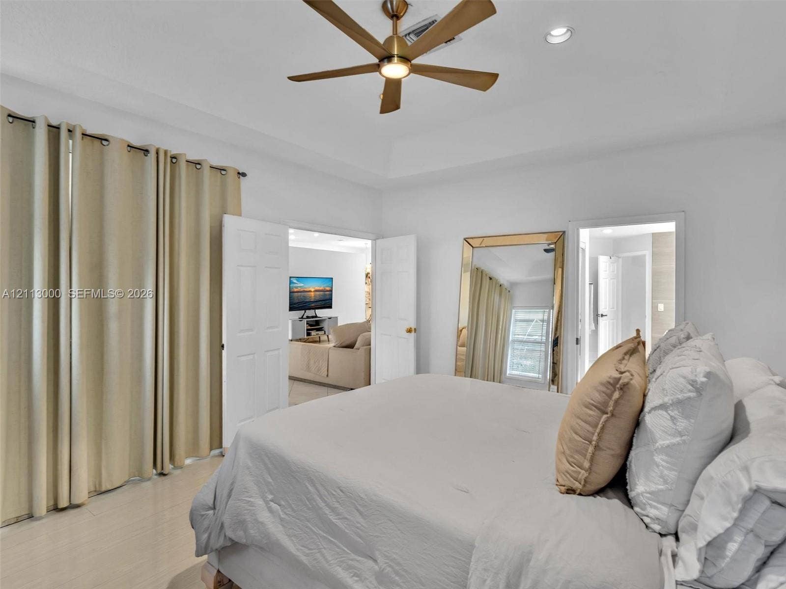 10860 La Salinas Circle, Boca Raton, FL 33428 Tray ceiling featuring a brushed-brass multi-blade ceiling fan and recessed lighting