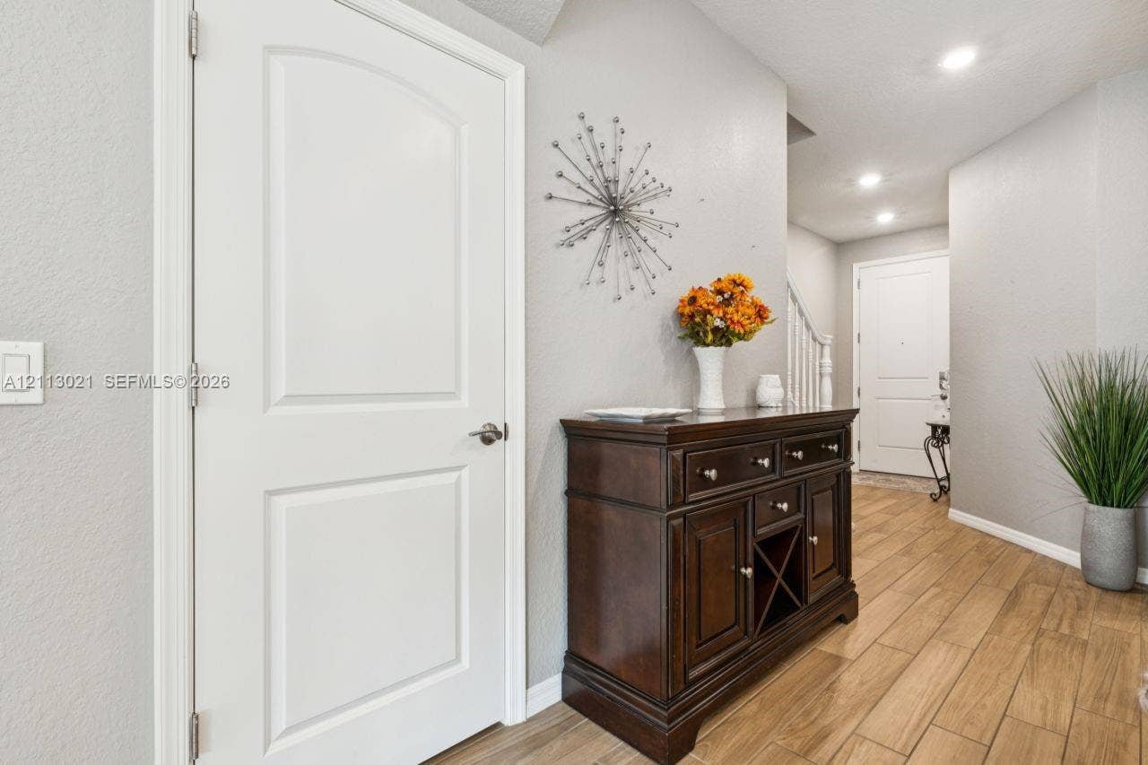 8228 Tailshot Court, Lake Worth, Lake Worth, FL 33467 Wood-finish flooring, recessed lighting, and white panel doors