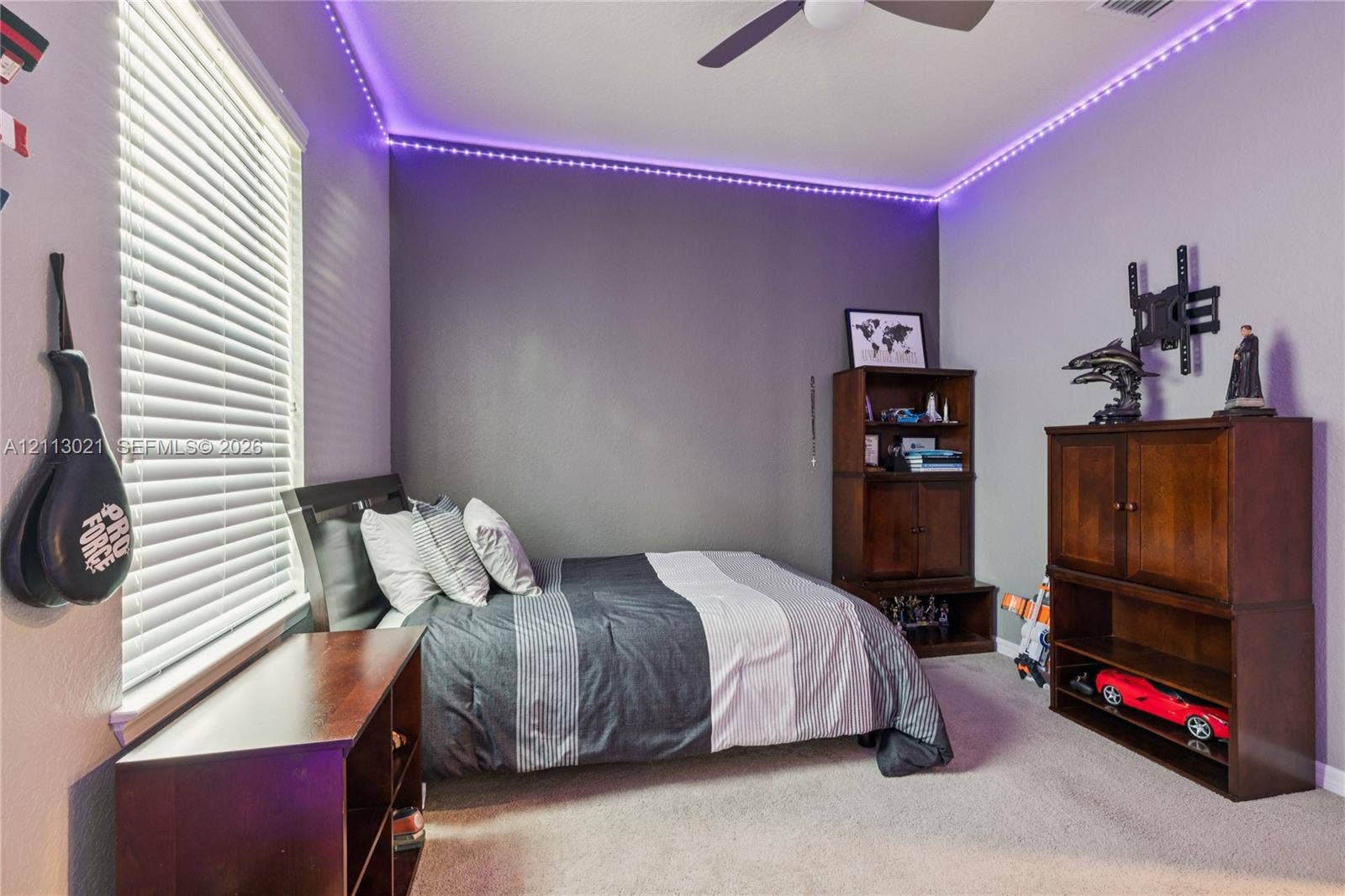 8228 Tailshot Court, Lake Worth, Lake Worth, FL 33467 Room featuring neutral carpeting, horizontal window blinds, and a ceiling fan with integrated lighting