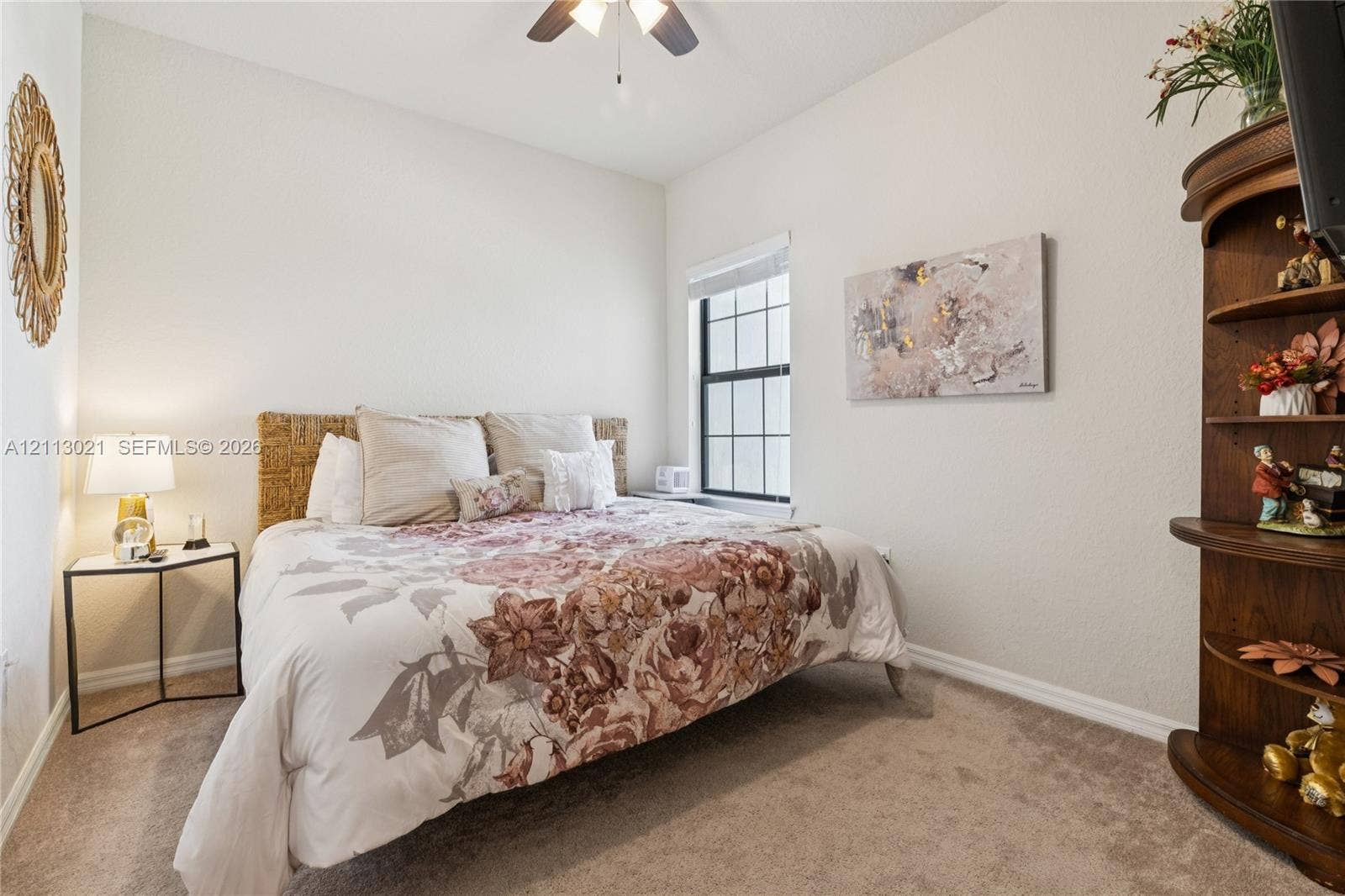 8228 Tailshot Court, Lake Worth, Lake Worth, FL 33467 Neutral-toned interior space featuring neutral wall-to-wall carpeting, a single-hung window with white framing, and a ceiling-mounted fan fixture