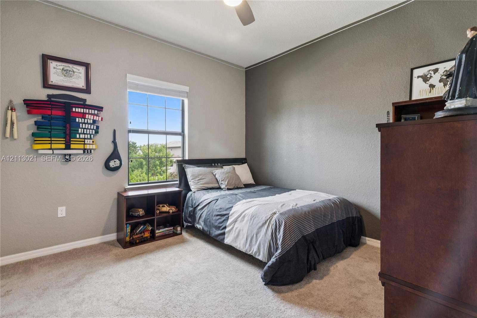 8228 Tailshot Court, Lake Worth, Lake Worth, FL 33467 Bedroom featuring neutral wall paint, carpeted flooring, a single-hung window with a grid pattern, and a ceiling-mounted light fixture