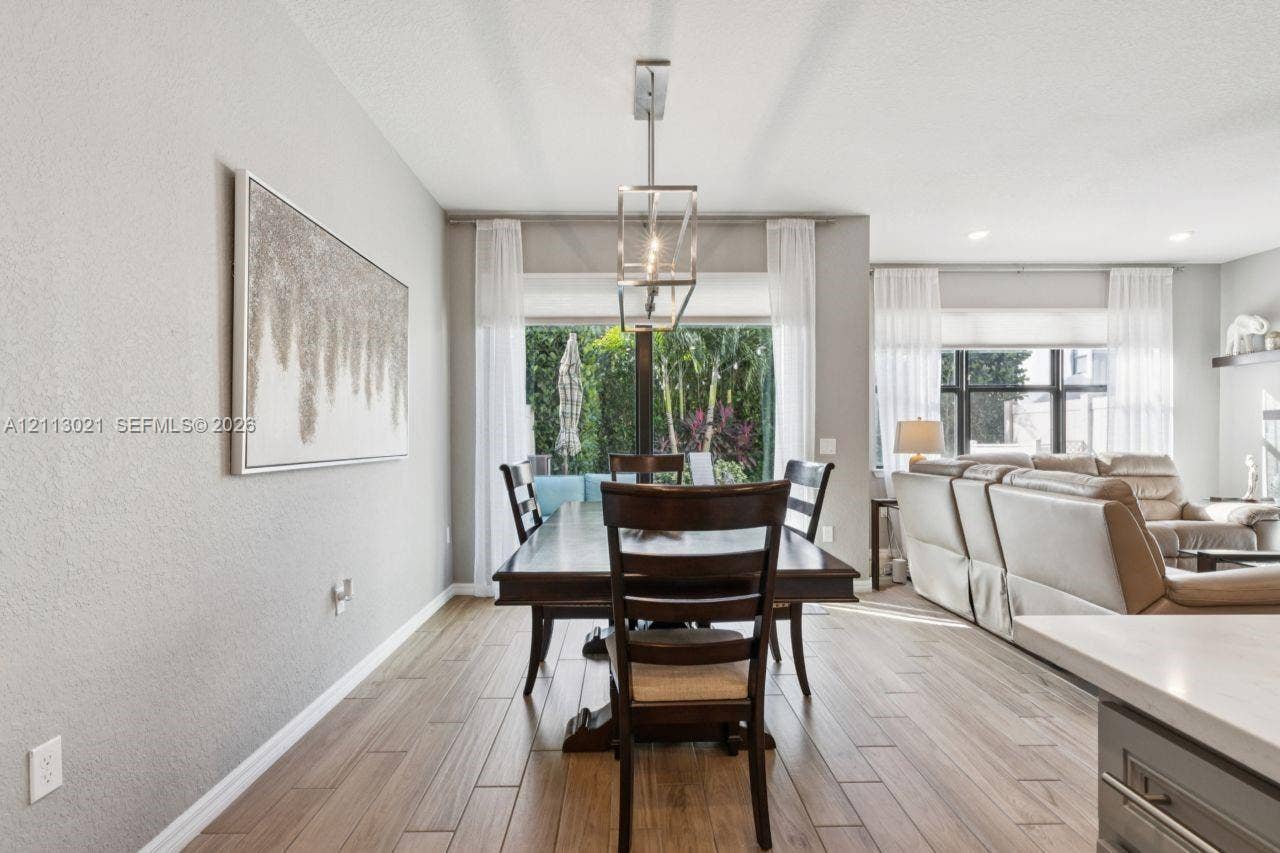 8228 Tailshot Court, Lake Worth, Lake Worth, FL 33467 Wood-finish tile flooring, recessed lighting, and a geometric metal pendant fixture