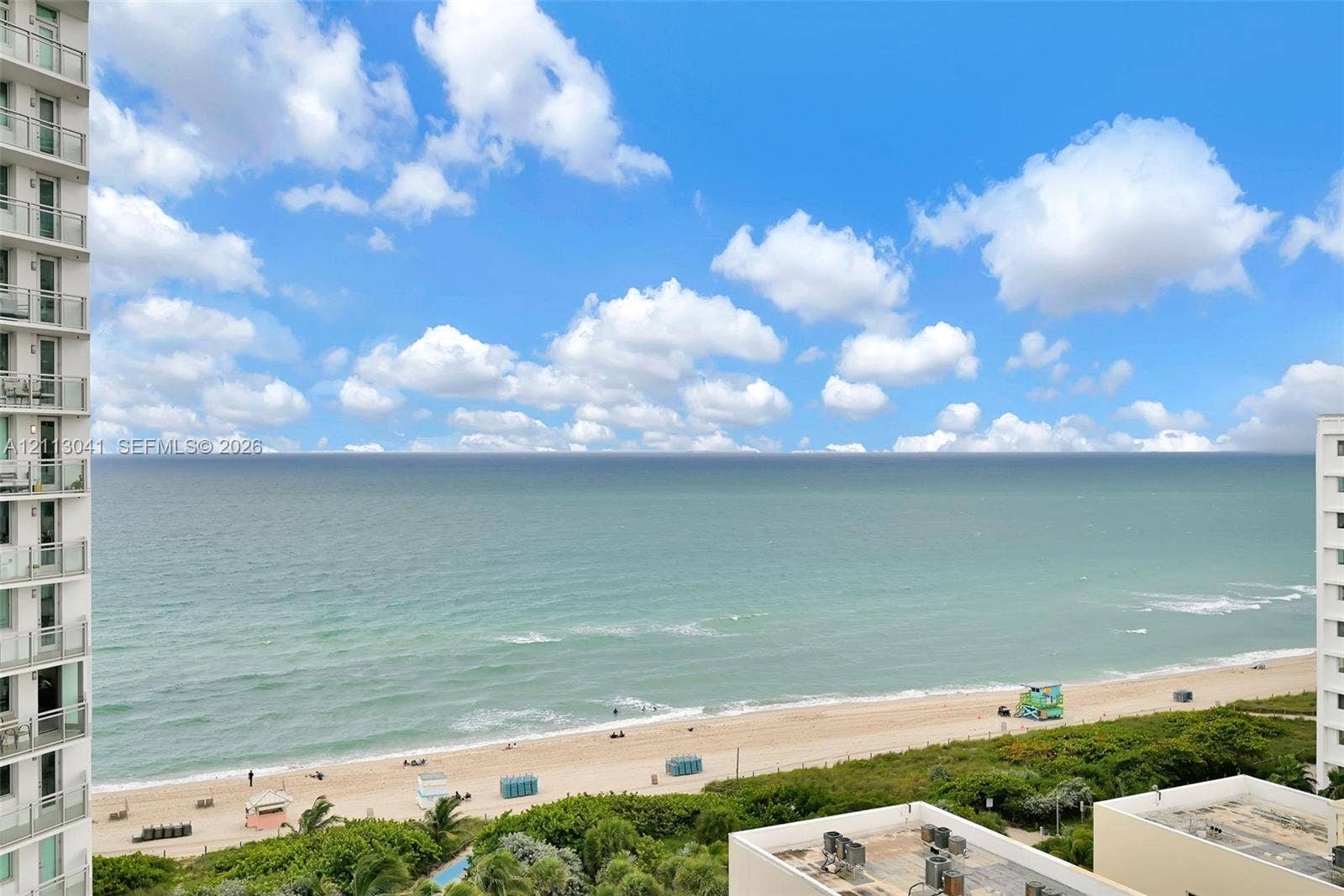 7135 Collins Avenue, #1426, Miami Beach, FL 33141 Oceanfront exterior featuring high-rise balconies with glass railings overlooking the coastline