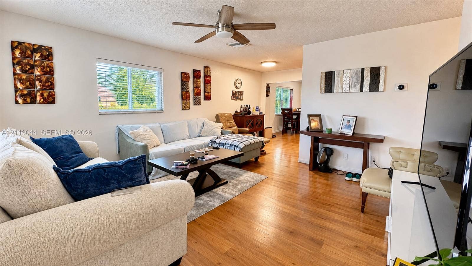 6735 NW 62nd Street, Tamarac, FL 33321 Wood-finish flooring, ceiling fan with integrated lighting, and horizontal window blinds