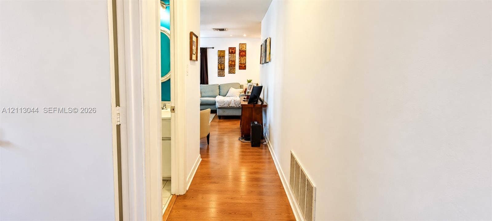6735 NW 62nd Street, Tamarac, FL 33321 Hallway featuring wood-finish flooring and recessed lighting