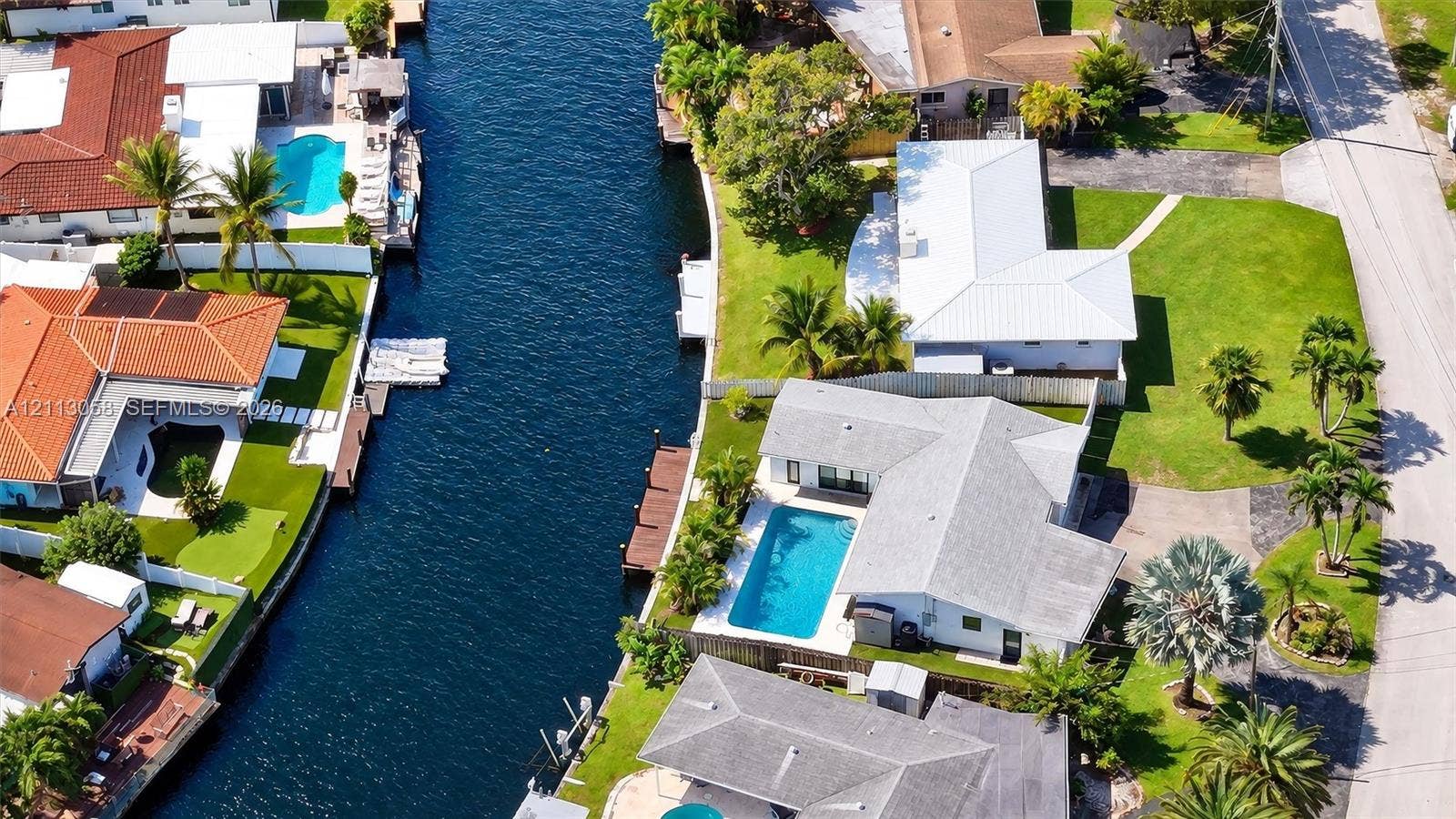 1980 NW 33rd Court, Oakland Park, FL 33309 Waterfront property featuring a private boat dock, canal access, and an in-ground swimming pool