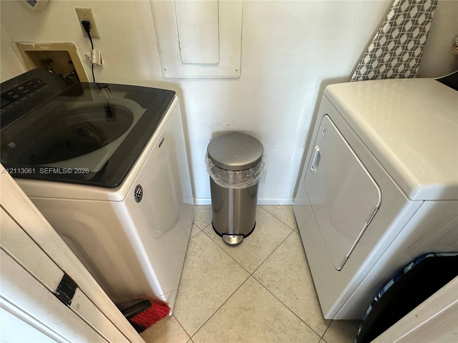 Laundry alcove featuring ceramic tile flooring and dedicated utility hookups