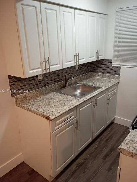 2222 Fillmore Street, #105, Hollywood, Hollywood, FL 33020 Kitchen featuring white shaker-style cabinetry, stone-finish countertops, stainless steel undermount sink, multi-tonal mosaic tile backsplash, and wood-finish flooring