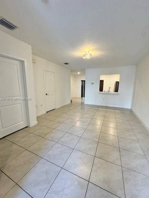 557 NE 5th Terrace, Florida City, Florida City, FL 33034 Ceramic tile flooring, neutral wall finishes, multi-panel interior doors, and a kitchen pass-through opening