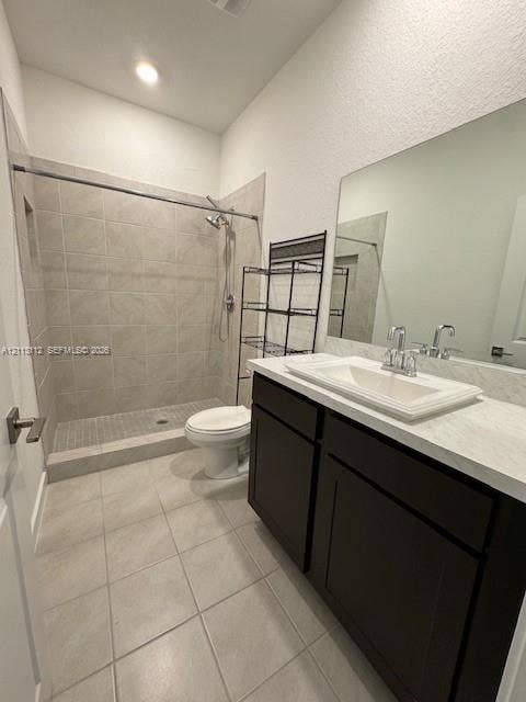557 NE 5th Terrace, Florida City, Florida City, FL 33034 Bathroom featuring a walk-in shower with tile surround, dark-finish cabinetry, light-toned countertop with an integrated basin, and large wall-mounted mirror