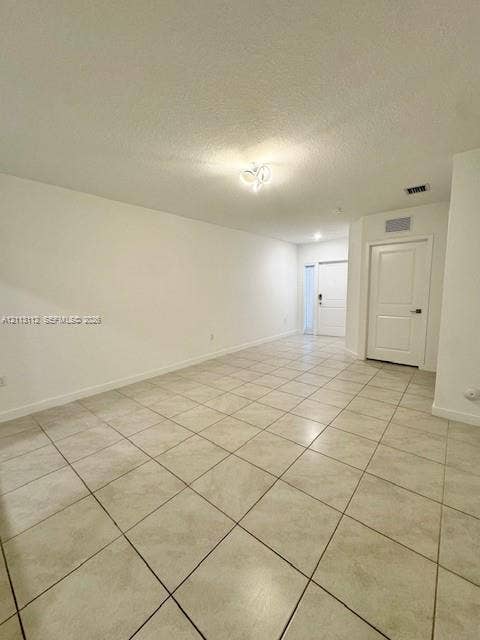 557 NE 5th Terrace, Florida City, Florida City, FL 33034 Neutral-toned ceramic tile flooring, multi-panel interior door, and decorative flush-mount ceiling lighting