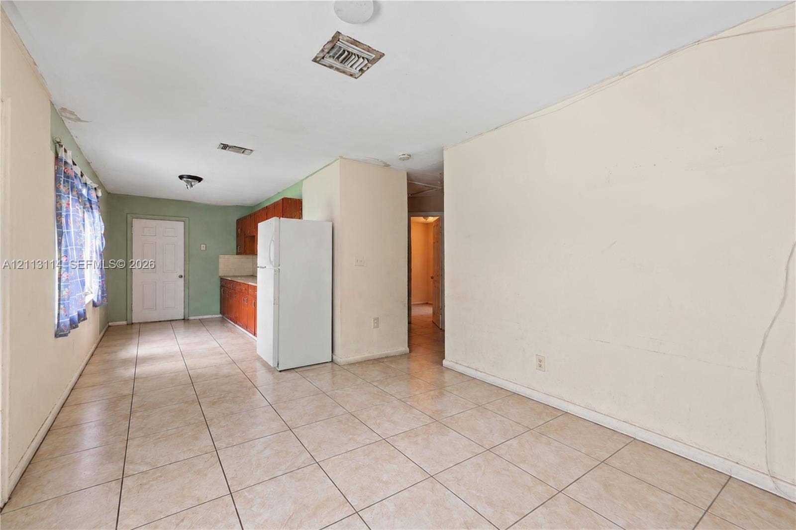 Interior space featuring tile flooring and wood-finish cabinetry