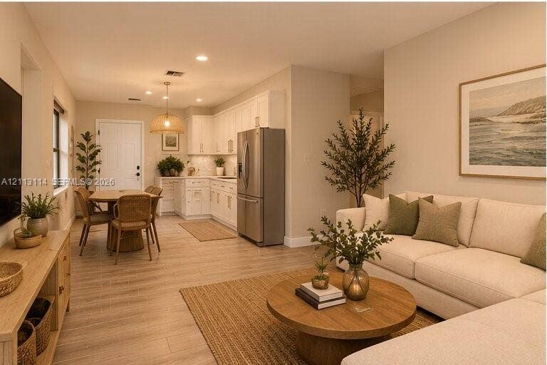 AI-generated photo of living room & kitchen featuring white shaker-style cabinetry, stainless steel refrigerator, recessed lighting, and wood-finish flooring throughout