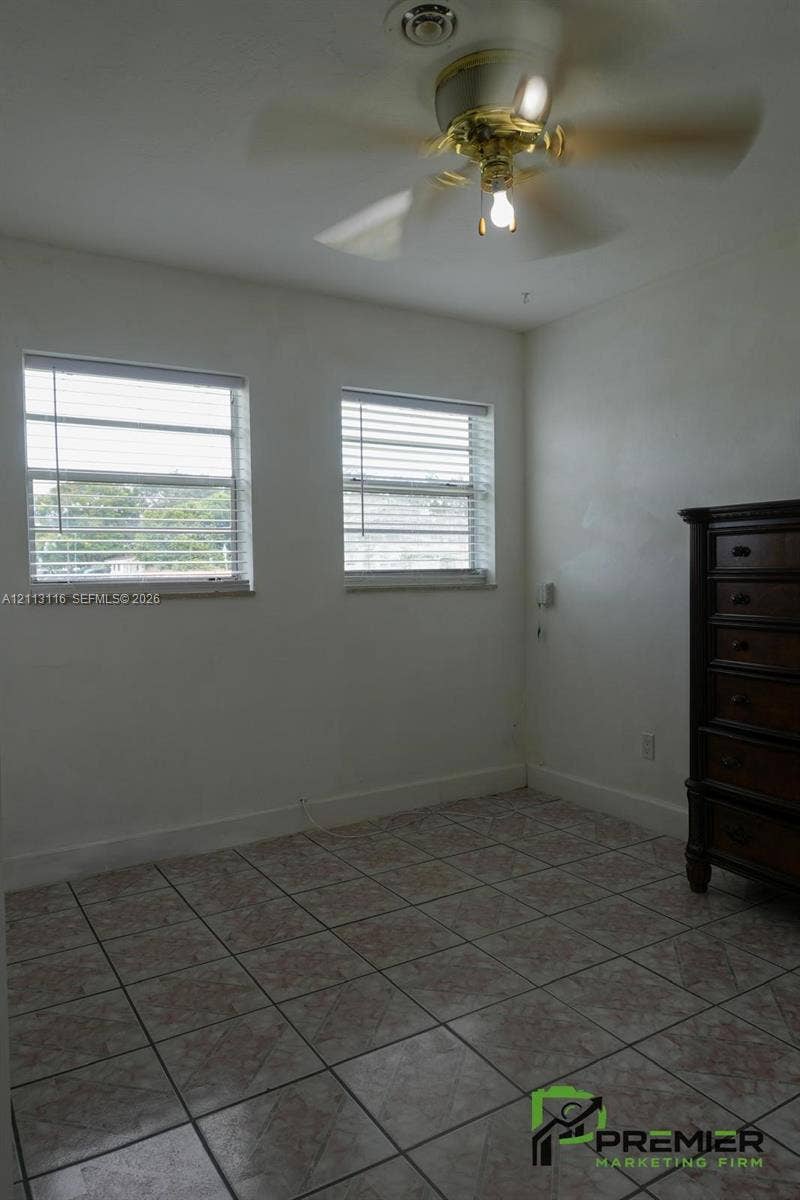 4341 NW 178th Drive, Miami Gardens, FL 33055 Room featuring tile flooring, dual windows with horizontal blinds, and a ceiling fan