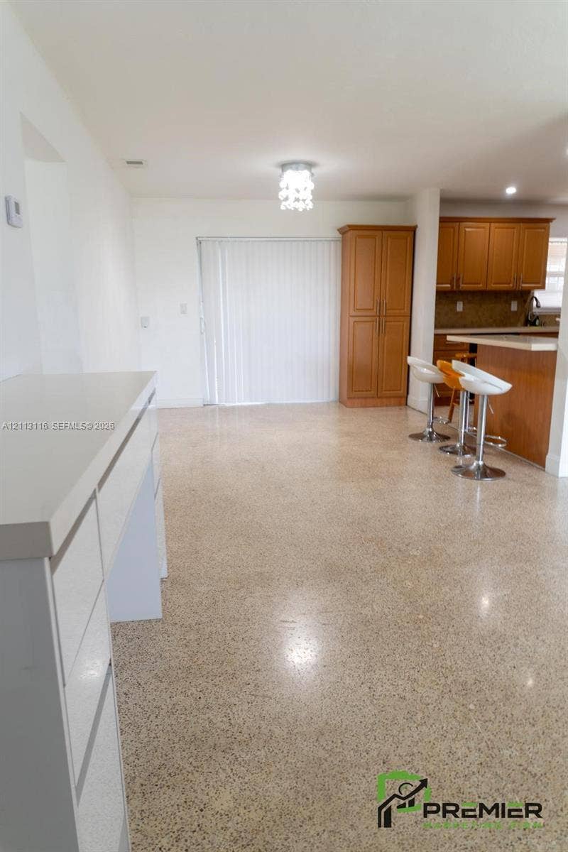4341 NW 178th Drive, Miami Gardens, FL 33055 Polished terrazzo flooring throughout, wood-finish cabinetry, built-in floor-to-ceiling storage, and quartz countertop surfaces