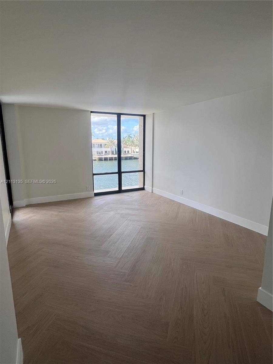 1600 S Ocean Drive, #3A, Hollywood, FL 33019 Herringbone wood-finish flooring, floor-to-ceiling windows with black metal frames, and water exposure