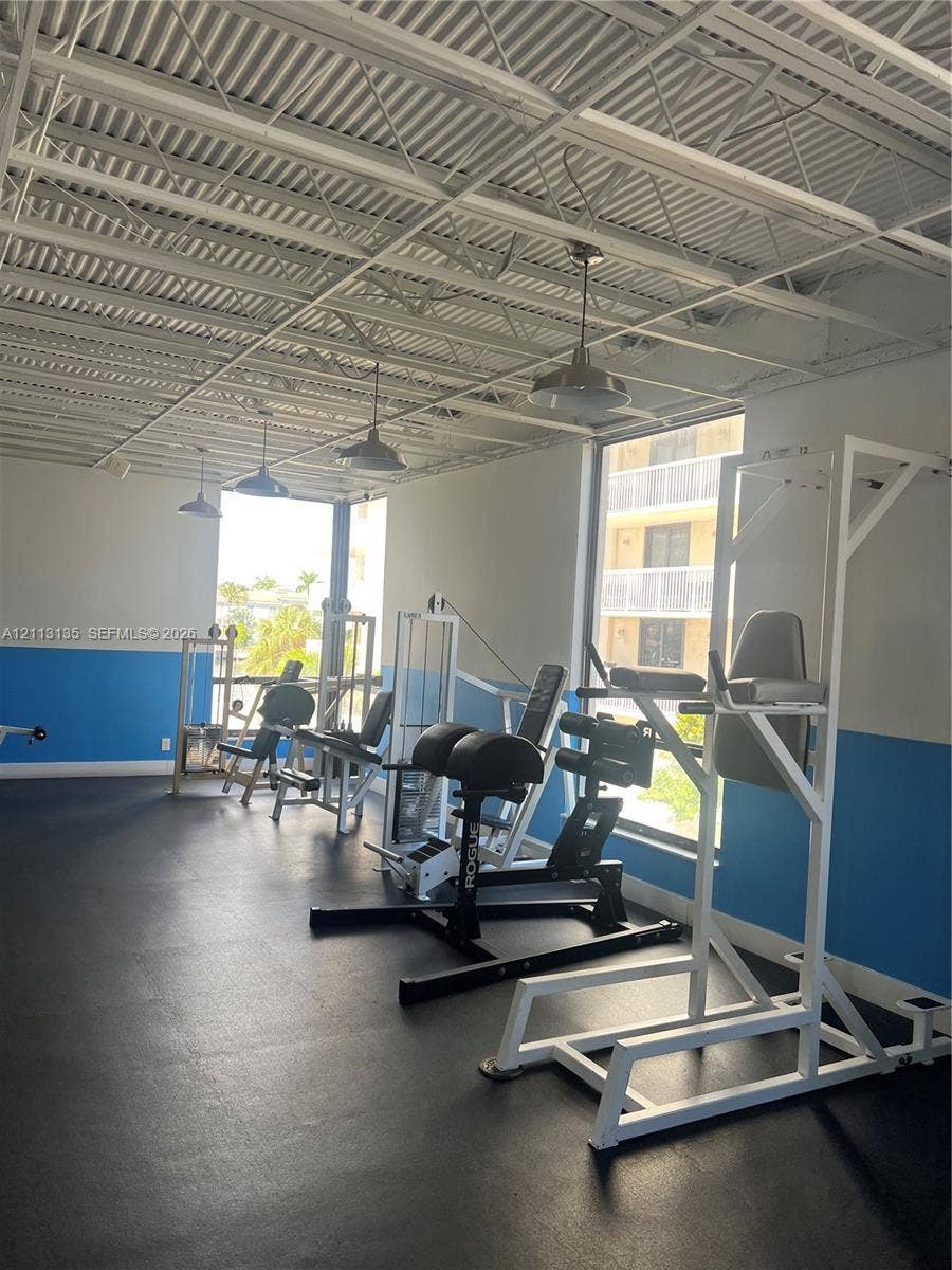 1600 S Ocean Drive, #3A, Hollywood, FL 33019 Fitness area featuring industrial exposed-truss ceilings, impact-resistant rubber flooring, and large windows with natural light