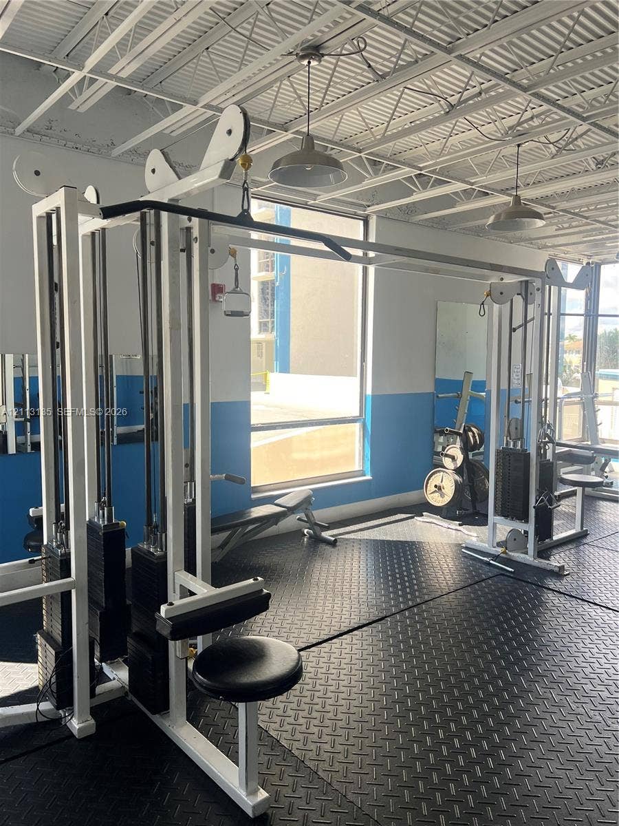 1600 S Ocean Drive, #3A, Hollywood, FL 33019 Fitness facility featuring high, exposed-joist ceilings, industrial-style pendant lighting, rubberized diamond-plate flooring, and large windows