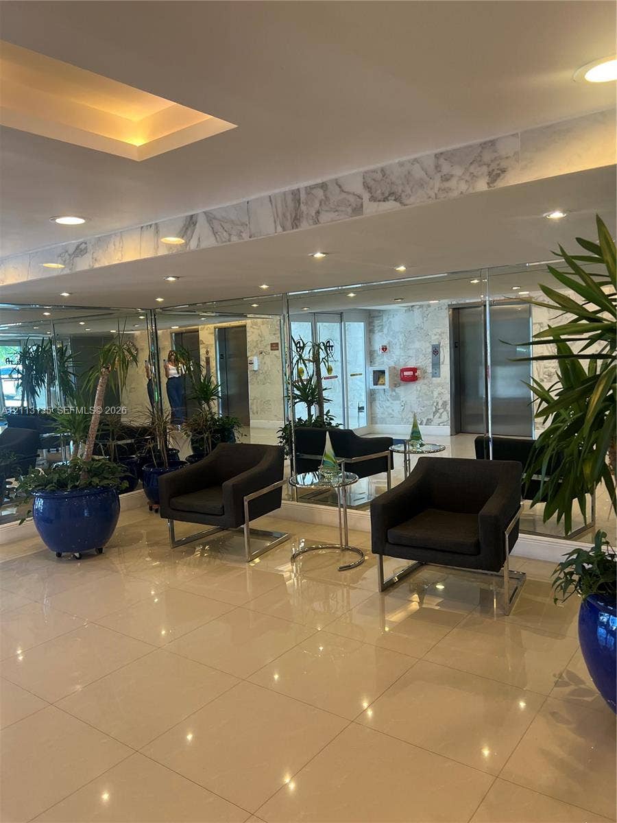 1600 S Ocean Drive, #3A, Hollywood, FL 33019 Reflective mirrored walls, recessed tray ceiling lighting, polished tile flooring, and stone-finish wall accents