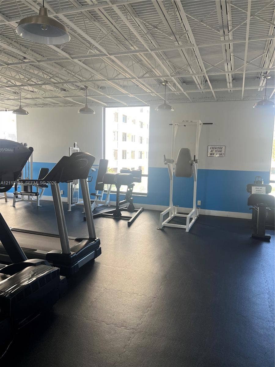 1600 S Ocean Drive, #3A, Hollywood, FL 33019 Fitness space featuring rubberized flooring, exposed industrial ceiling, and pendant lighting
