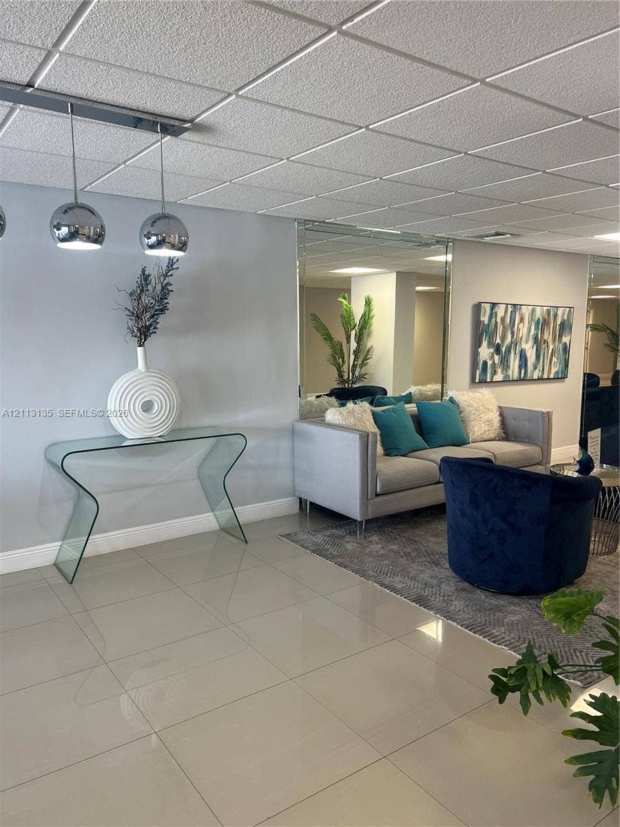 1600 S Ocean Drive, #3A, Hollywood, FL 33019 Large-format tile flooring, reflective wall-mounted mirror, and metallic globe pendant lighting