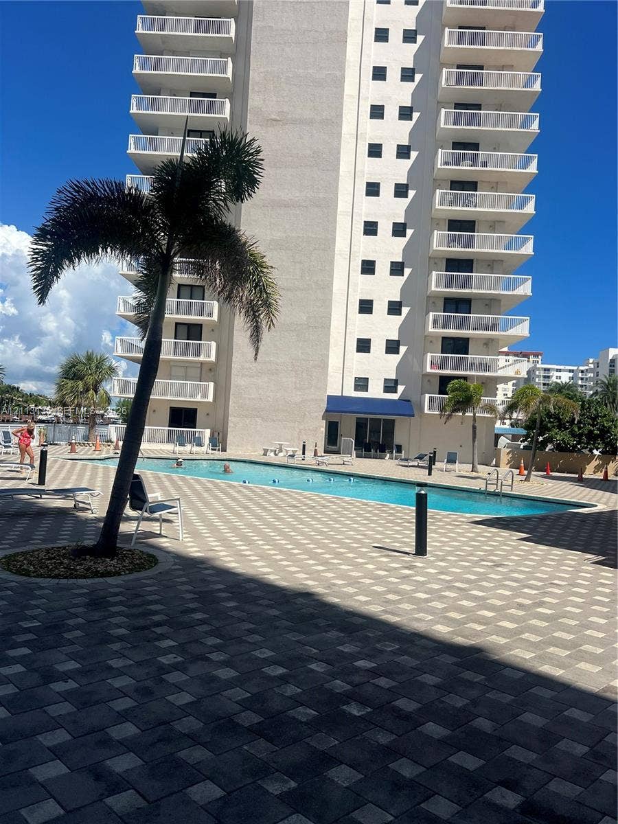 1600 S Ocean Drive, #3A, Hollywood, FL 33019 High-rise building featuring stacked private balconies, an outdoor swimming pool, and stone-paver decking
