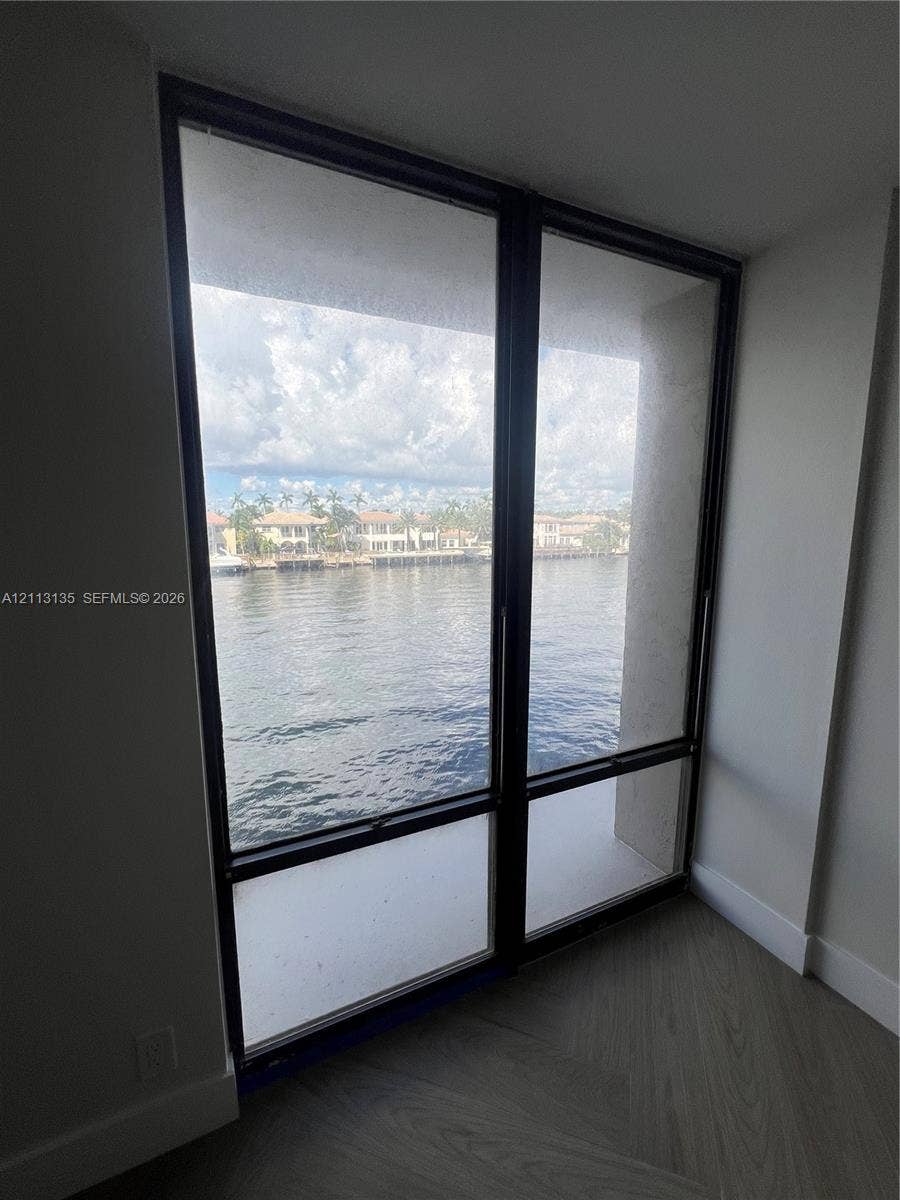 1600 S Ocean Drive, #3A, Hollywood, FL 33019 Floor-to-ceiling windows with dark metal frames, wood-finish flooring, and expansive water exposure