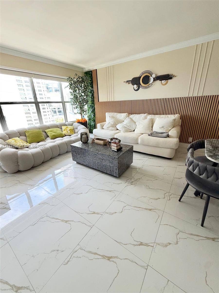 Large format white tile flooring with veining, vertical wood-slat accent wall, and expansive floor-to-ceiling windows