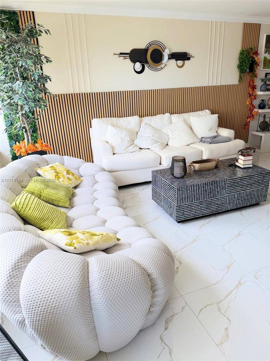 Large-format tile flooring with veining, vertical wood slat accent wall paneling, and integrated wall molding