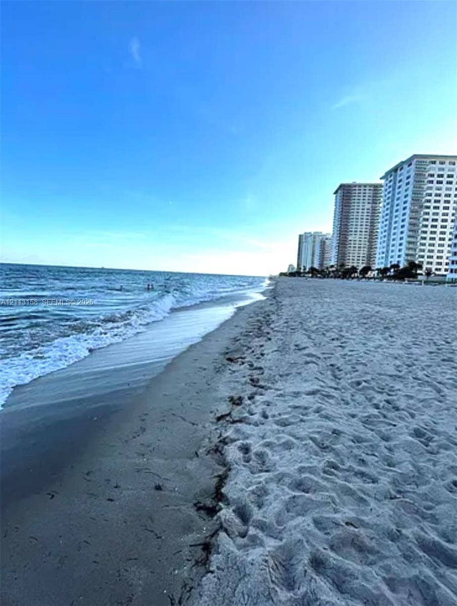 Sandy beachfront access with shoreline and coastal scenery
