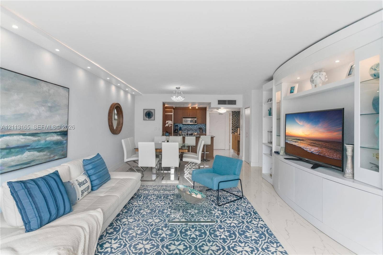 10275 Collins Avenue, #229, Bal Harbour, FL 33154 Custom built-in media cabinetry featuring recessed lighting, glass-front shelving, and stone-finish flooring