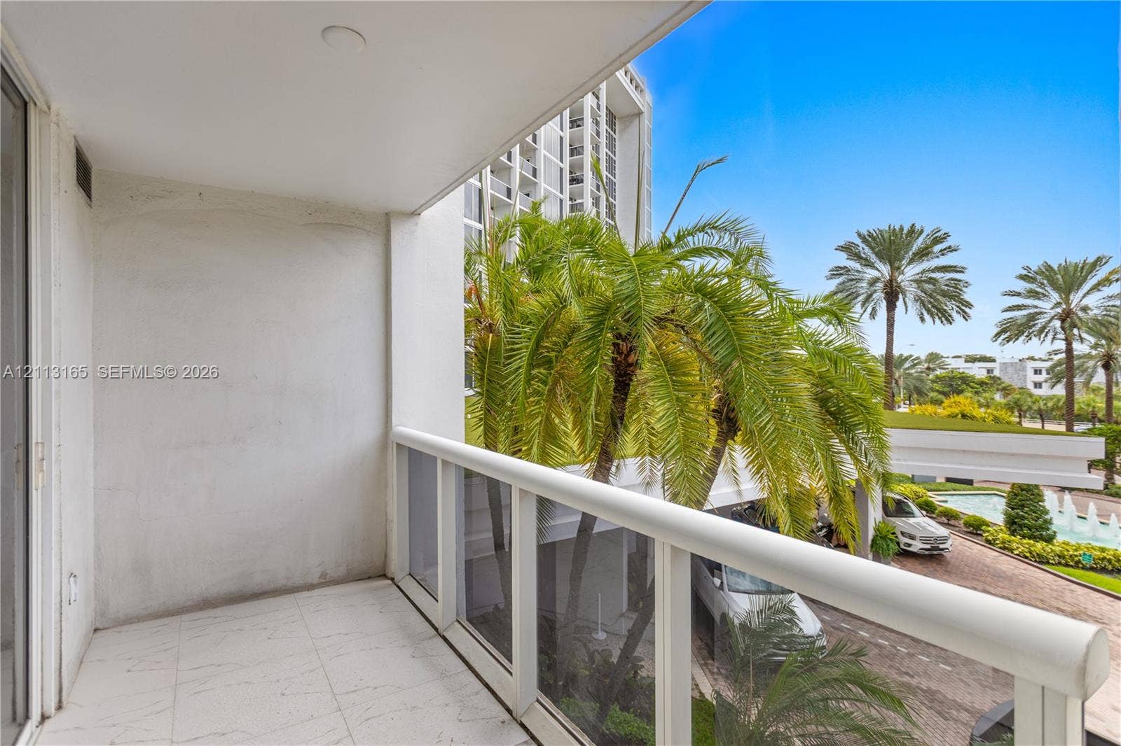 10275 Collins Avenue, #229, Bal Harbour, FL 33154 Covered balcony featuring white tiled flooring and a white railing