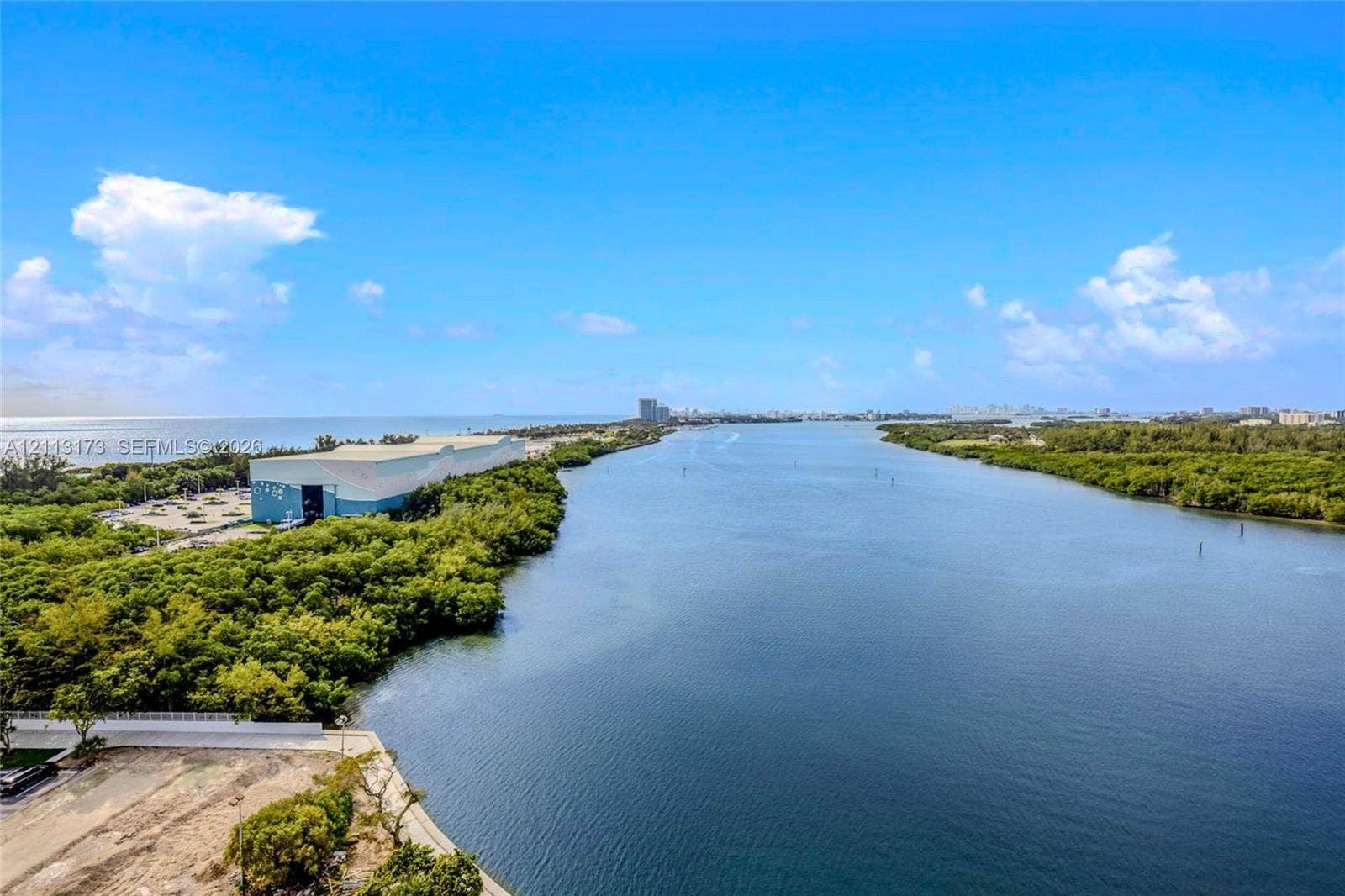 300 Bayview Drive, #1614, Sunny Isles Beach, FL 33160 Aerial perspective featuring expansive open water, dense coastal vegetation, and a wide horizon