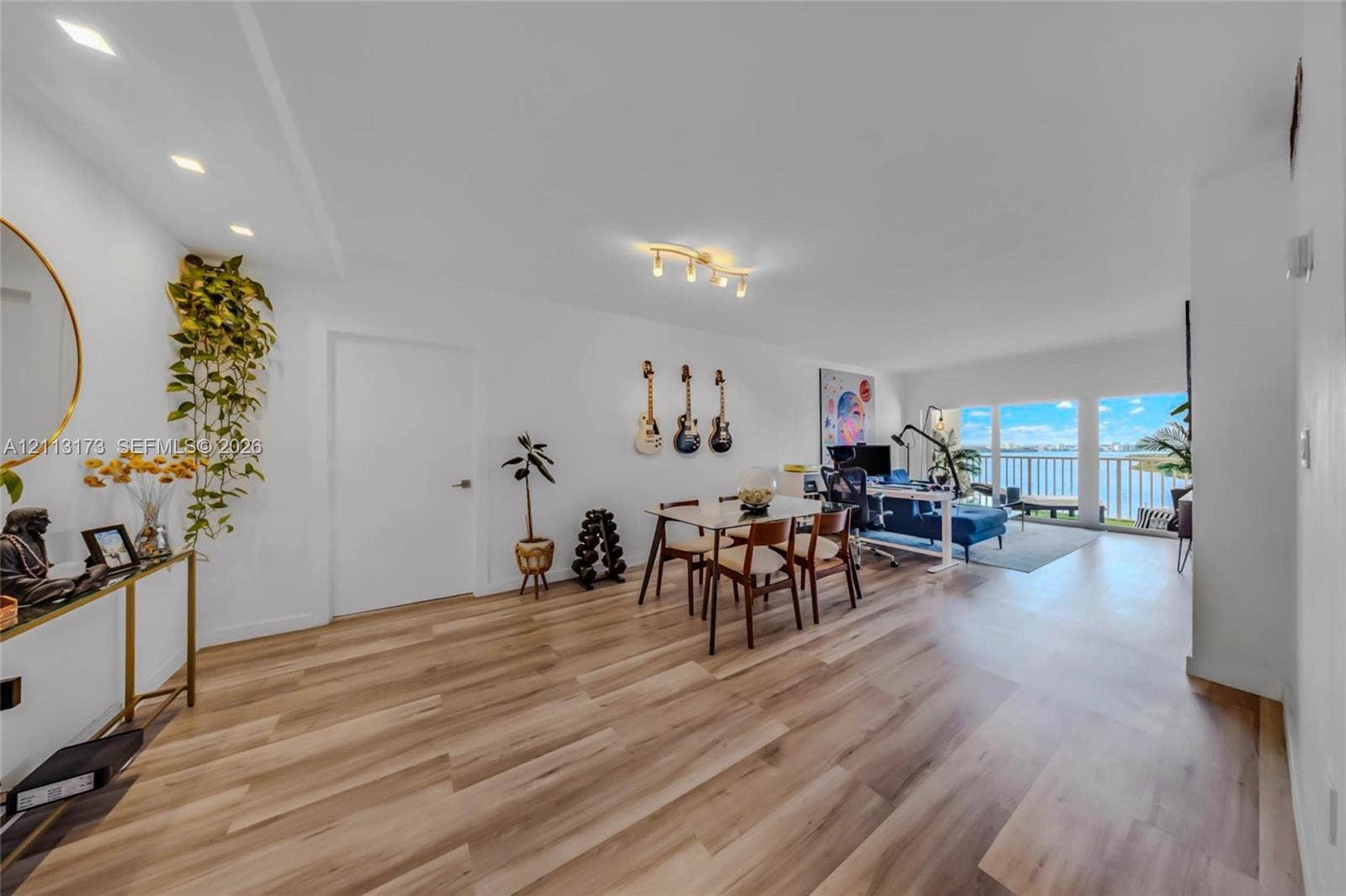 300 Bayview Drive, #1614, Sunny Isles Beach, FL 33160 Open-concept interior featuring wood-finish flooring, recessed lighting, and expansive glass doors opening to a balcony