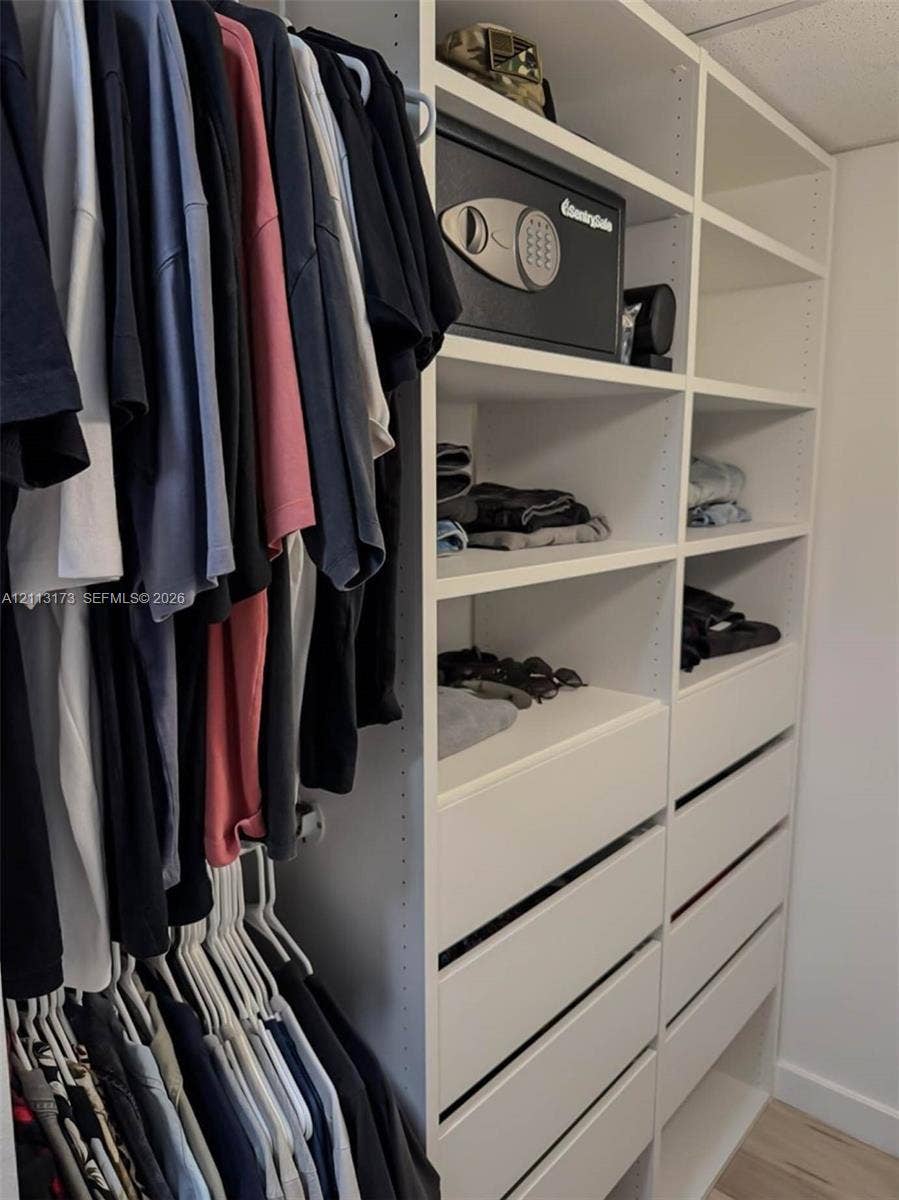 300 Bayview Drive, #1614, Sunny Isles Beach, FL 33160 Custom built-in closet organization system featuring floor-to-ceiling shelving, tiered hanging rods, and integrated pull-out drawers
