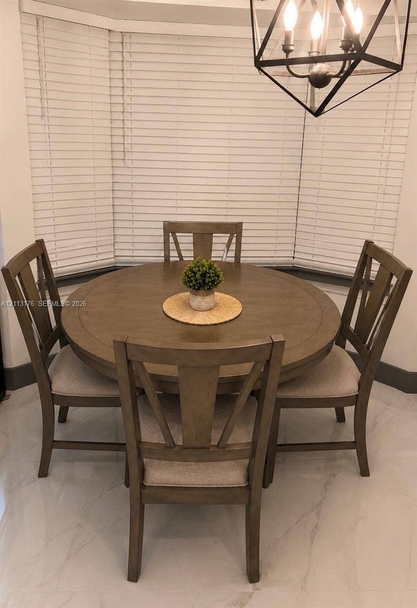 4391 NW 112th Avenue, Coral Springs, FL 33065 Bay window featuring horizontal blinds, large-format tile flooring, and a geometric metal pendant light fixture