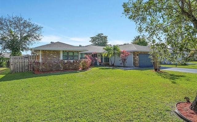 4391 NW 112th Avenue, Coral Springs, FL 33065 Single-story residence featuring a brick and stucco exterior, expansive lawn, mature landscaping, multi-car garage, and wood fencing