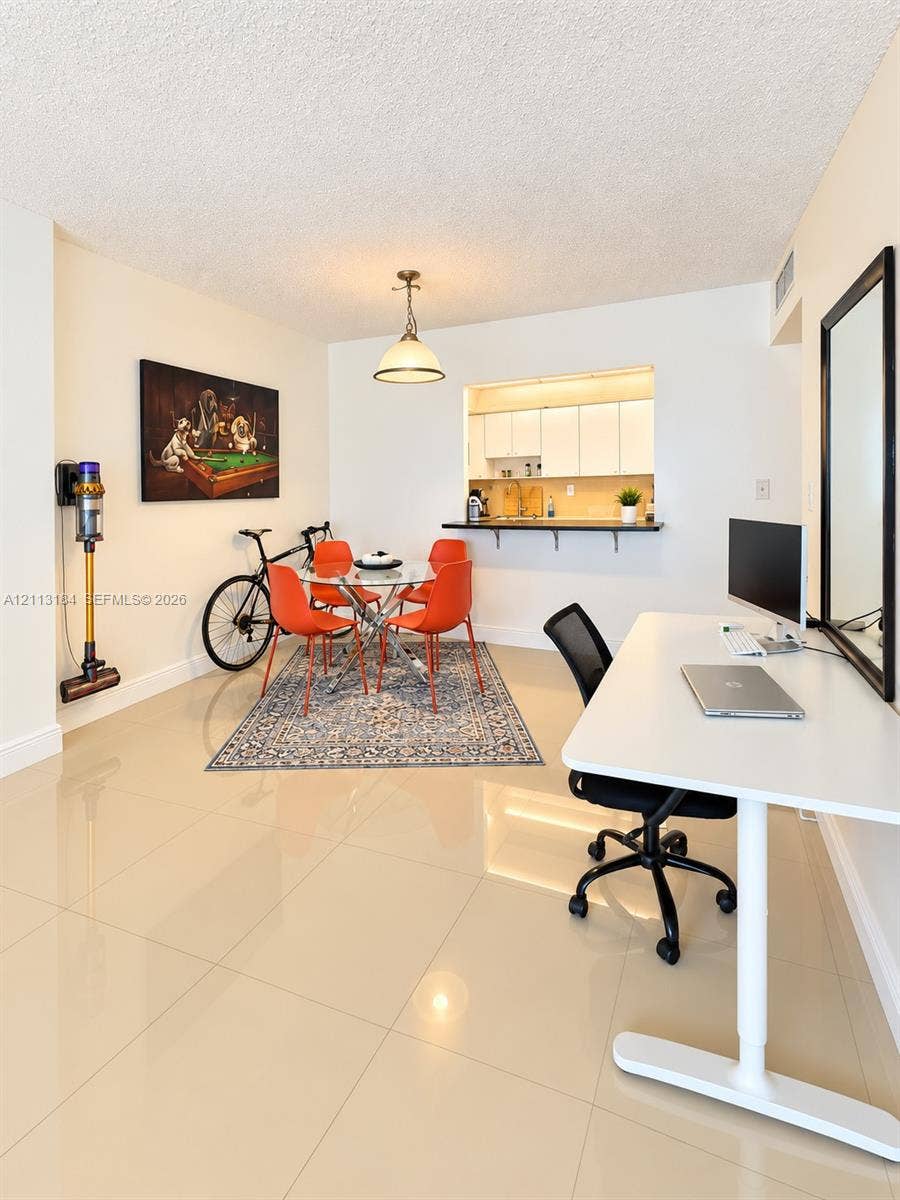 19380 Collins Avenue, #708, Sunny Isles Beach, Sunny Isles Beach, FL 33160 Polished tile flooring throughout, recessed kitchen pass-through window, and pendant lighting