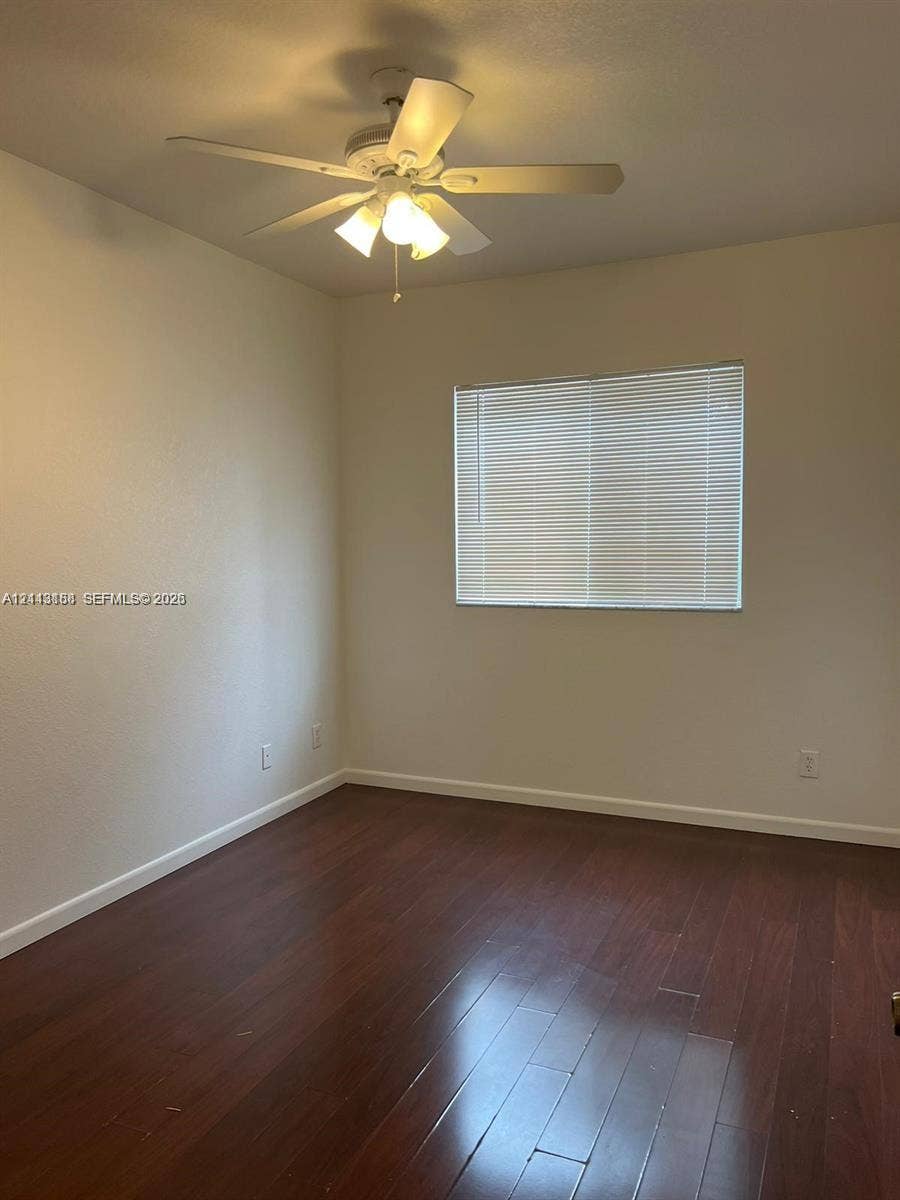 8706 NW 38th Drive, #2, Coral Springs, Coral Springs, FL 33065 Room featuring wood-finish flooring, a multi-blade ceiling fan with integrated lighting, and horizontal window blinds