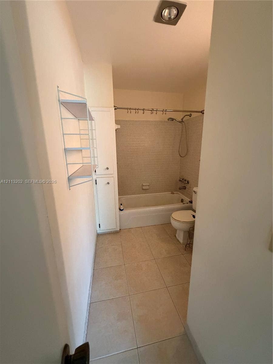 5700 NE 22nd Way, #324, Fort Lauderdale, Fort Lauderdale, FL 33308 Bathroom featuring tile flooring, a shower and tub combination with tiled surround, and built-in vertical cabinetry