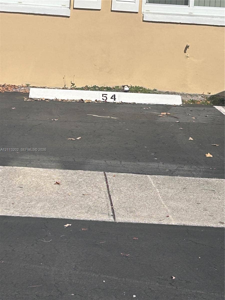 5700 NE 22nd Way, #324, Fort Lauderdale, Fort Lauderdale, FL 33308 Designated parking space 54 with asphalt surfacing and concrete curbing