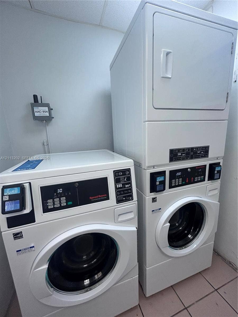 5700 NE 22nd Way, #324, Fort Lauderdale, Fort Lauderdale, FL 33308 Commercial-grade front-loading washer and stackable dryer unit with digital control interfaces and tile flooring