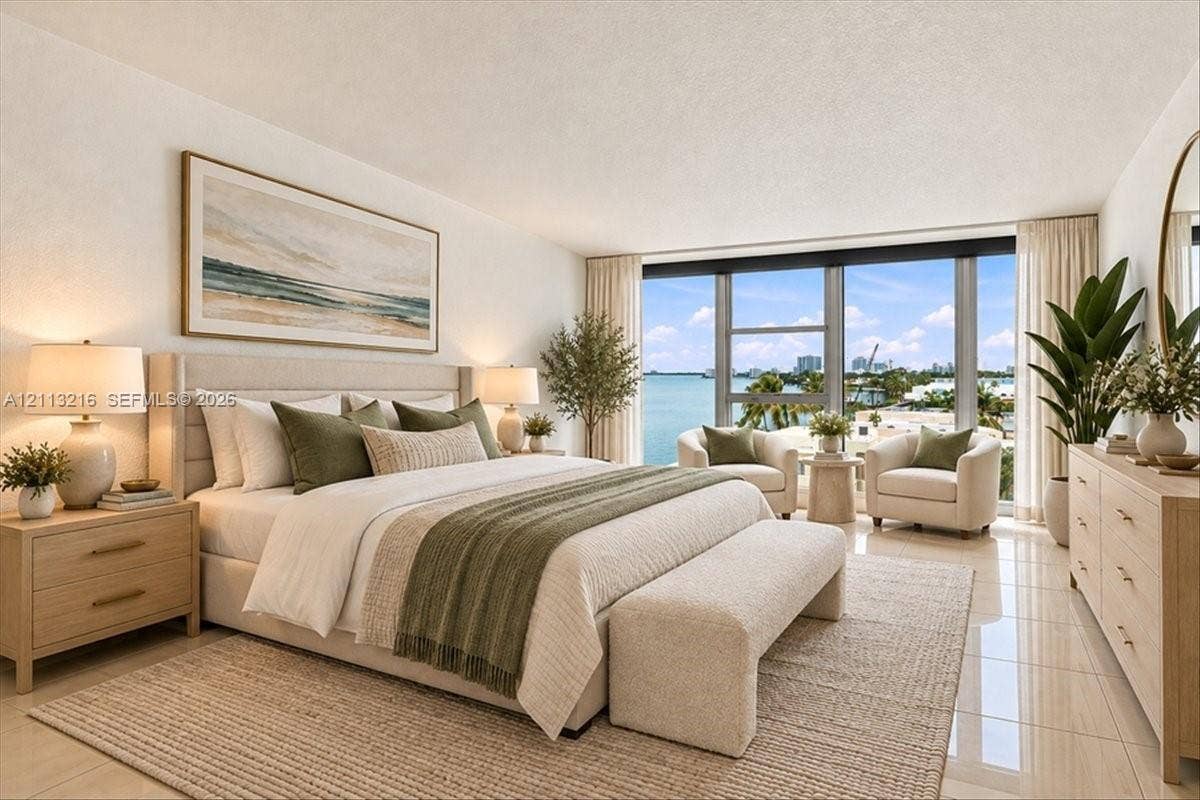 900 Bay Drive, #425, Miami Beach, FL 33141 Floor-to-ceiling windows featuring expansive coastal scenery, neutral tile flooring, and a sleek, minimalist aesthetic