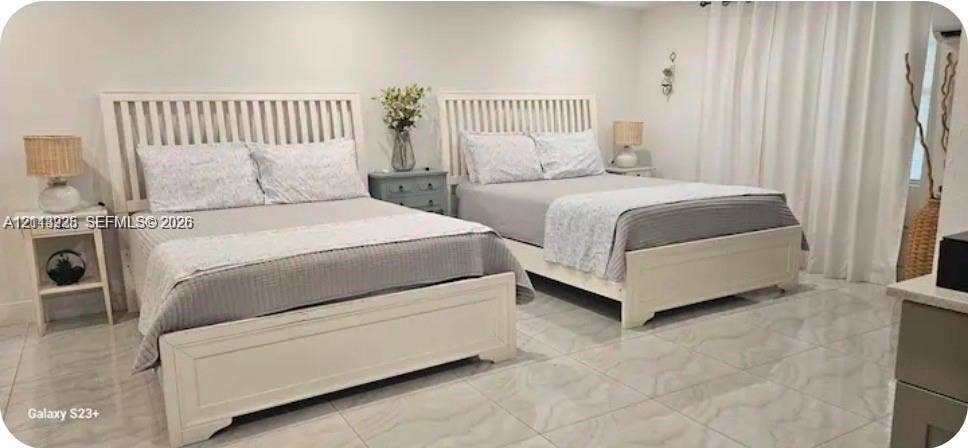 144 NW 7th Avenue, #2, Dania, Dania Beach, FL 33004 Neutral-toned room featuring large-format stone-finish floor tiling and floor-to-ceiling window drapery