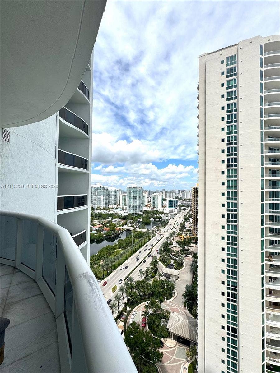 16001 Collins Avenue, #2403, Sunny Isles Beach, Sunny Isles Beach, FL 33160 Curved balcony featuring glass panel railings and tiled flooring