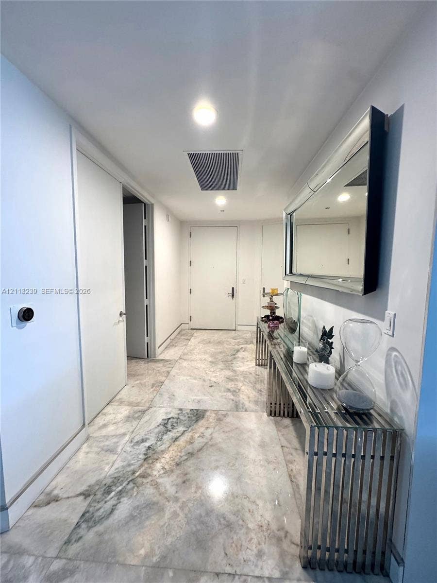 16001 Collins Avenue, #2403, Sunny Isles Beach, Sunny Isles Beach, FL 33160 Foyer featuring large-format stone flooring, recessed lighting, and a solid-core door